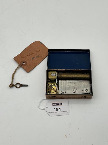 Lot 184 - A miniature Swiss musical box with printed...