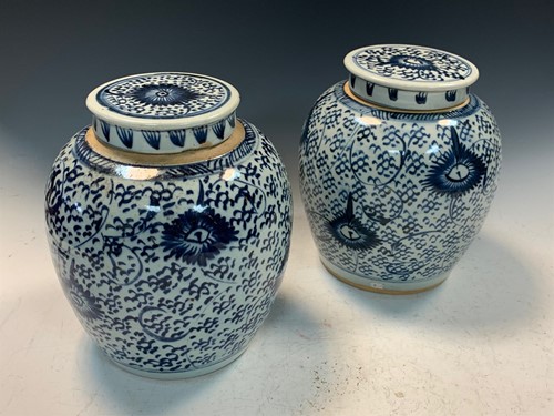 Lot 18 - A pair of provincial blue and white ginger jars with covers, 19th century