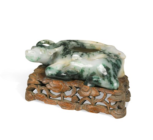 Lot 37 - A Chinese mottled green and grey jade recumbent water buffalo, late Qing Dynasty, in Ming style