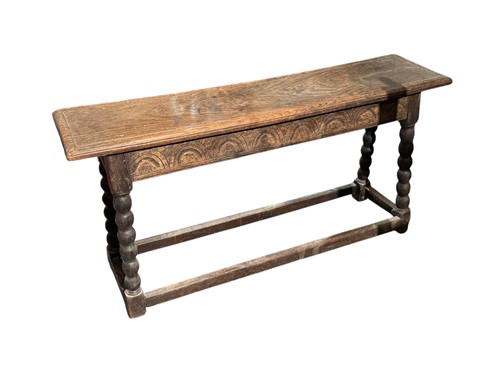 Lot 720 - A 17th century style oak bench with demilune...