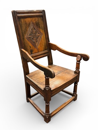 Lot 584 - A 17th century style oak armchair