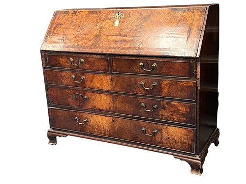 Lot 612 - A large George III mahogany and crossbanded bureau