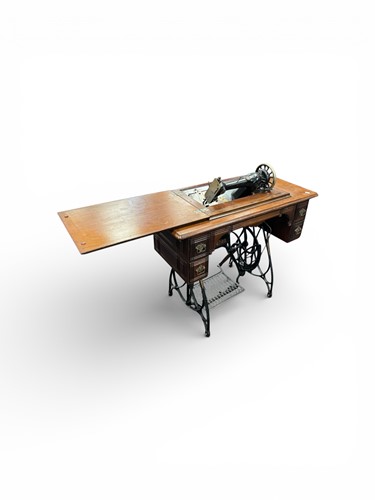 Lot 628 - A 19th century Federation sewing machine treadle table