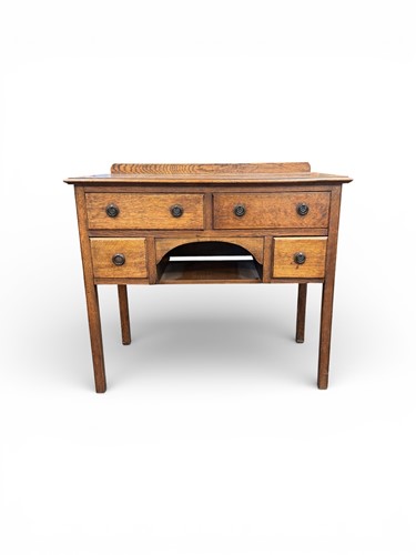 Lot 622 - An early 20th century small oak desk with faux...