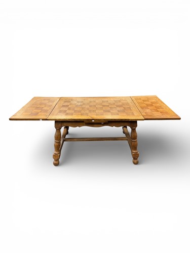 Lot 576 - A blonde oak draw-leaf table, 20th century
