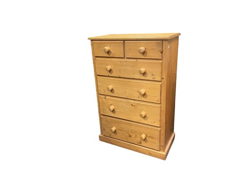 Lot 581 - A tall pine chest of drawers, modern, two over...