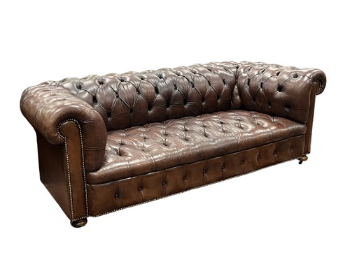 Lot 591 - A brown leather buttoned back chesterfield sofa, early 20th century