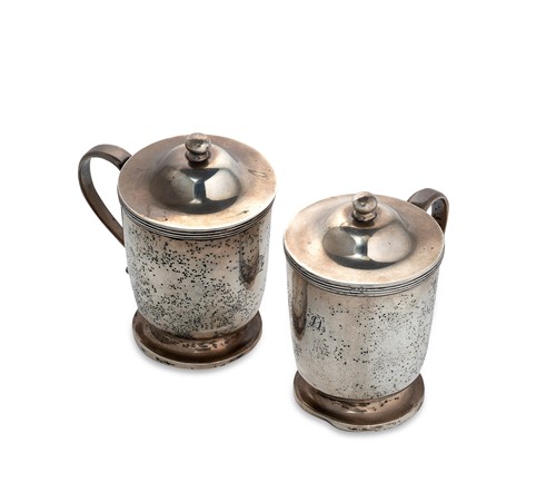 Lot 452 - A pair of Indian Colonial silver mugs with covers