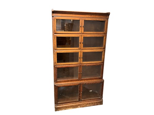 Lot 715 - An oak five section stacking glazed bookcase,...