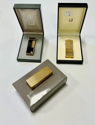 Lot 365 - Three Dunhill lighters, two gold plated and...