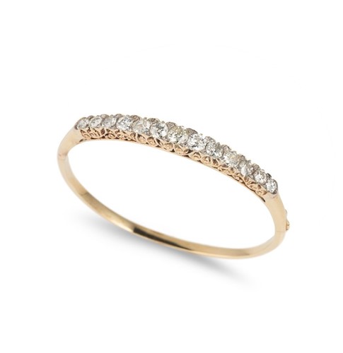 Lot 177 - An Edwardian carved half hoop style diamond bangle