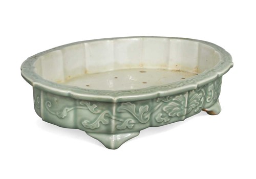 Lot 67 - An Oriental celadon glazed shallow jardiniere,...