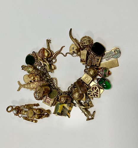 Lot 339 - A hallmarked 9ct gold charm bracelet with...