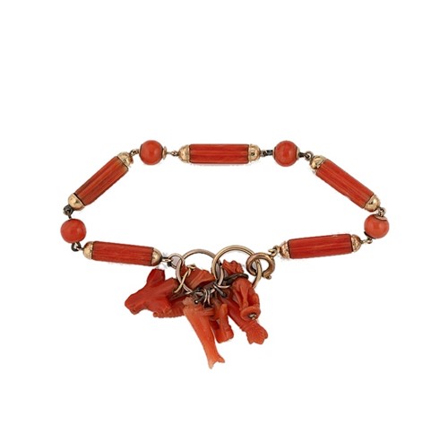 Lot 31 - A 19th century carved coral charm bracelet