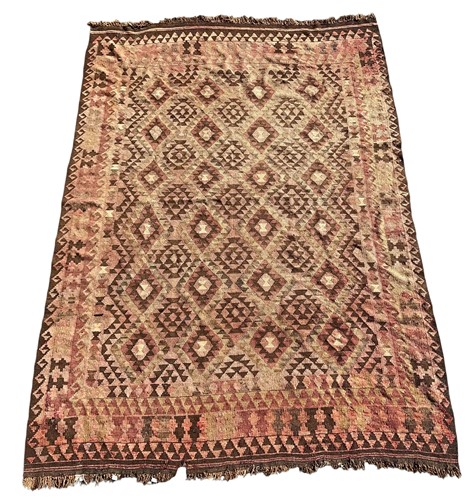 Lot 445 - A flatweave kilim in muted tones of red,...