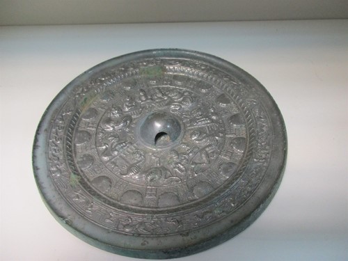 Lot 74 - A Tang silvered bronze mirror in a brocaded box