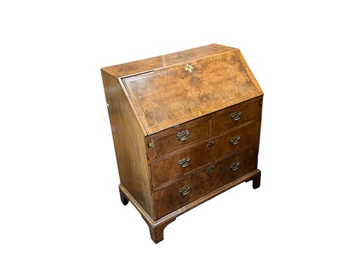 Lot 634 - A walnut bureau, 18th century, the fall front...