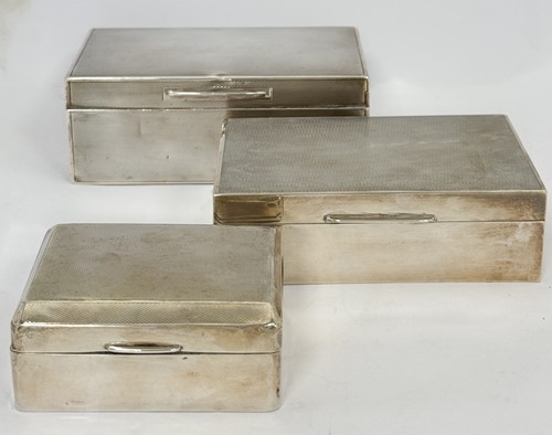 Lot 8 - Three silver cigarette boxes, each with engine-...