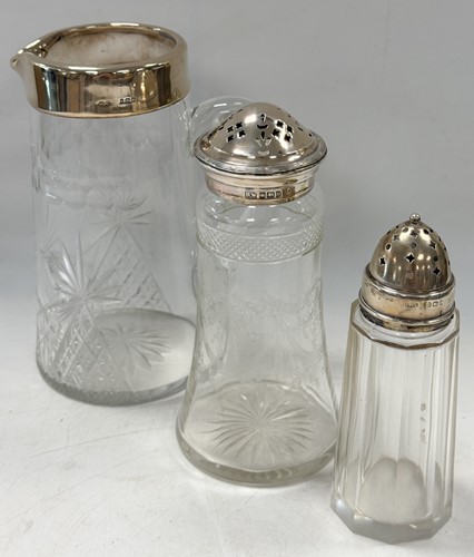 Lot 309 - Two silver mounted cut glass sifters and a...