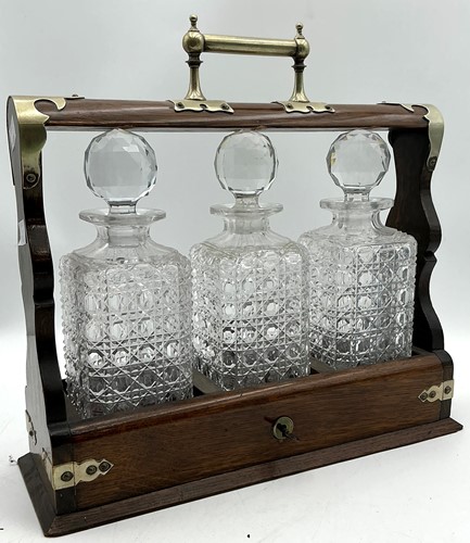 Lot 72 - An electroplate mounted oak three bottle tantalus