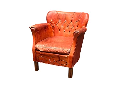 Lot 597 - A red leather buttoned back armchair, early...