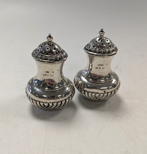 Lot 117 - A pair of silver pepperettes