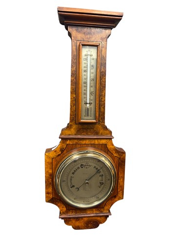 Lot 317 - A burr walnut aneroid barometer by Harrods