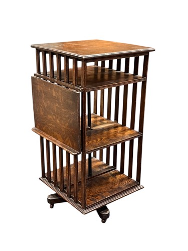 Lot 594 - An oak revolving bookcase, 20th century, with...