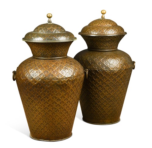 Lot 517 - A large pair of Middle Eastern metal baluster urns with covers, modern