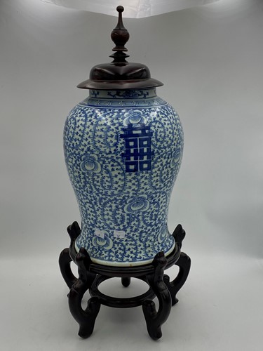 Lot 114 - A blue and white Chinese vase with wooden lid...