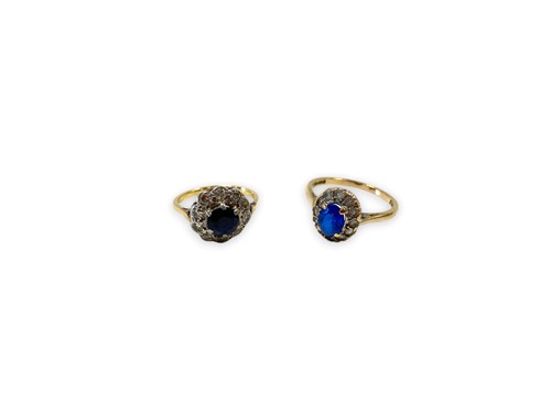 Lot 182 - A sapphire and diamond cluster ring, tested as...