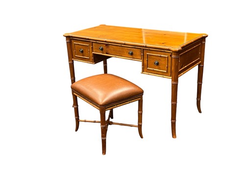 Lot 542 - A faux bamboo desk and matching stool by Ethan...