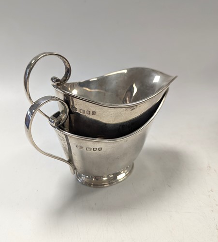 Lot 111 - A pair of modern cream jugs