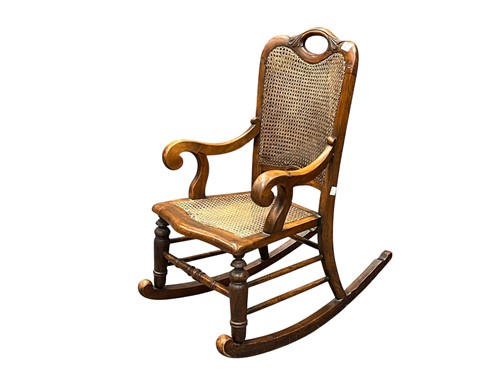 Lot 653 - An Edwardian miniature rocking chair, caned...