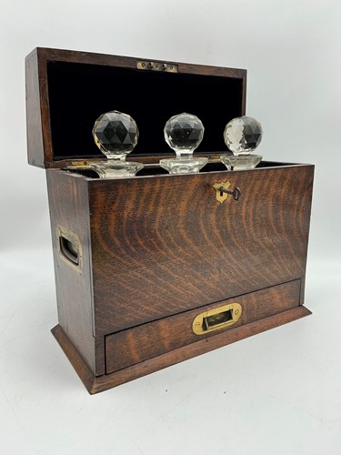 Lot 206 - A three bottle oak cased tantalus, late...