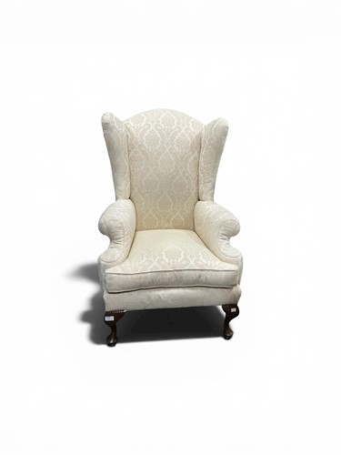 Lot 580 - A small wing chair, 20th century, set on short...