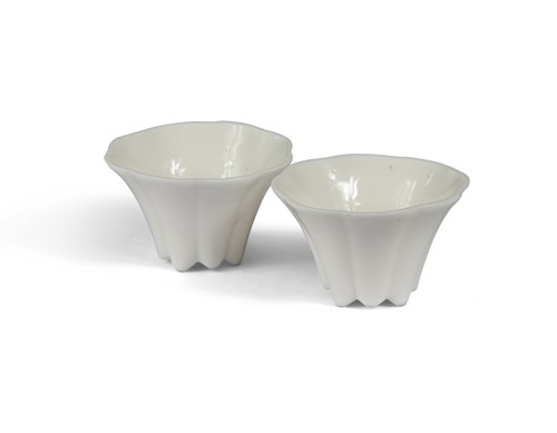Lot 24 - A pair of Chinese Dehua flower shaped white cups, late 17th century