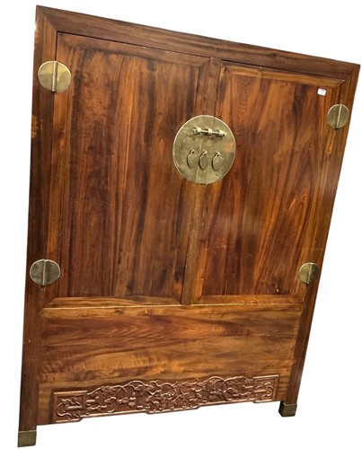Lot 558 - A large Chinese cupboard, with two doors over...