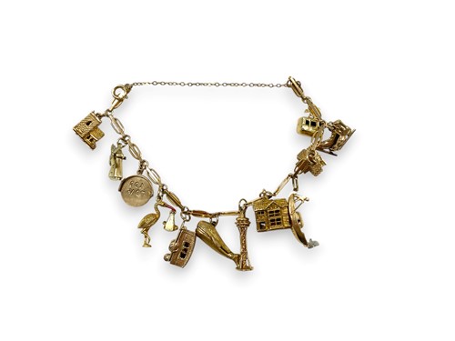 Lot 198 - A charm bracelet tested as 9ct gold,...
