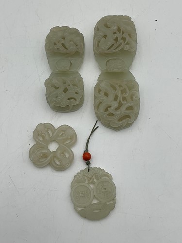 Lot 54 - Two carved white jade belt buckles, 20th...