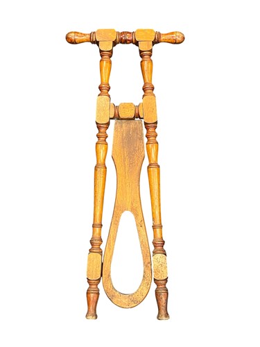 Lot 622 - A walnut boot jack, early 20th century, with...