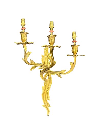 Lot 308 - A rococo style gilt brass three branch wall...