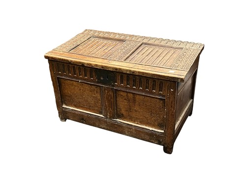 Lot 515 - A small carved oak two panelled coffer, 17th...
