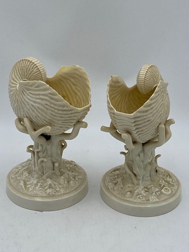 Lot 4 - A composed pair of Belleek nautilus vases on...