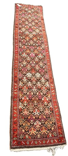 Lot 447 - A Persian runner rug with repeating design 320...