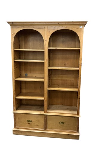 Lot 584 - An early 20th century pine bookcase, with two...
