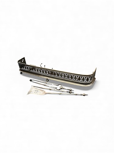 Lot 692 - A steel fender and fire irons, to include...