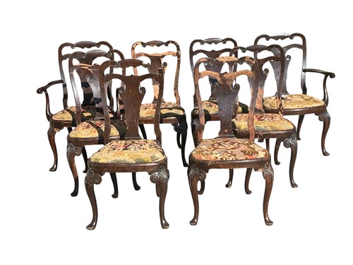 Lot 739 - A set of eight George II style walnut dining...