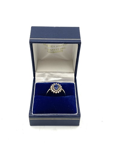 Lot 193 - A sapphire and diamond cluster ring, estimated...