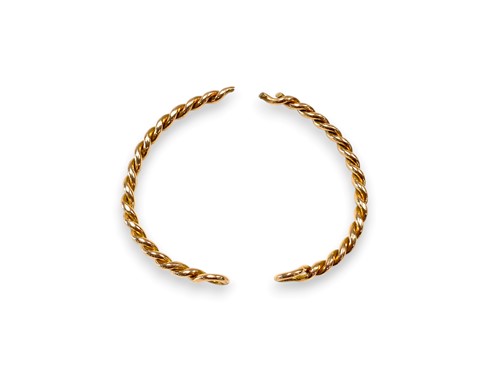 Lot 211 - A bangle in two sections, tested as 9ct gold,...